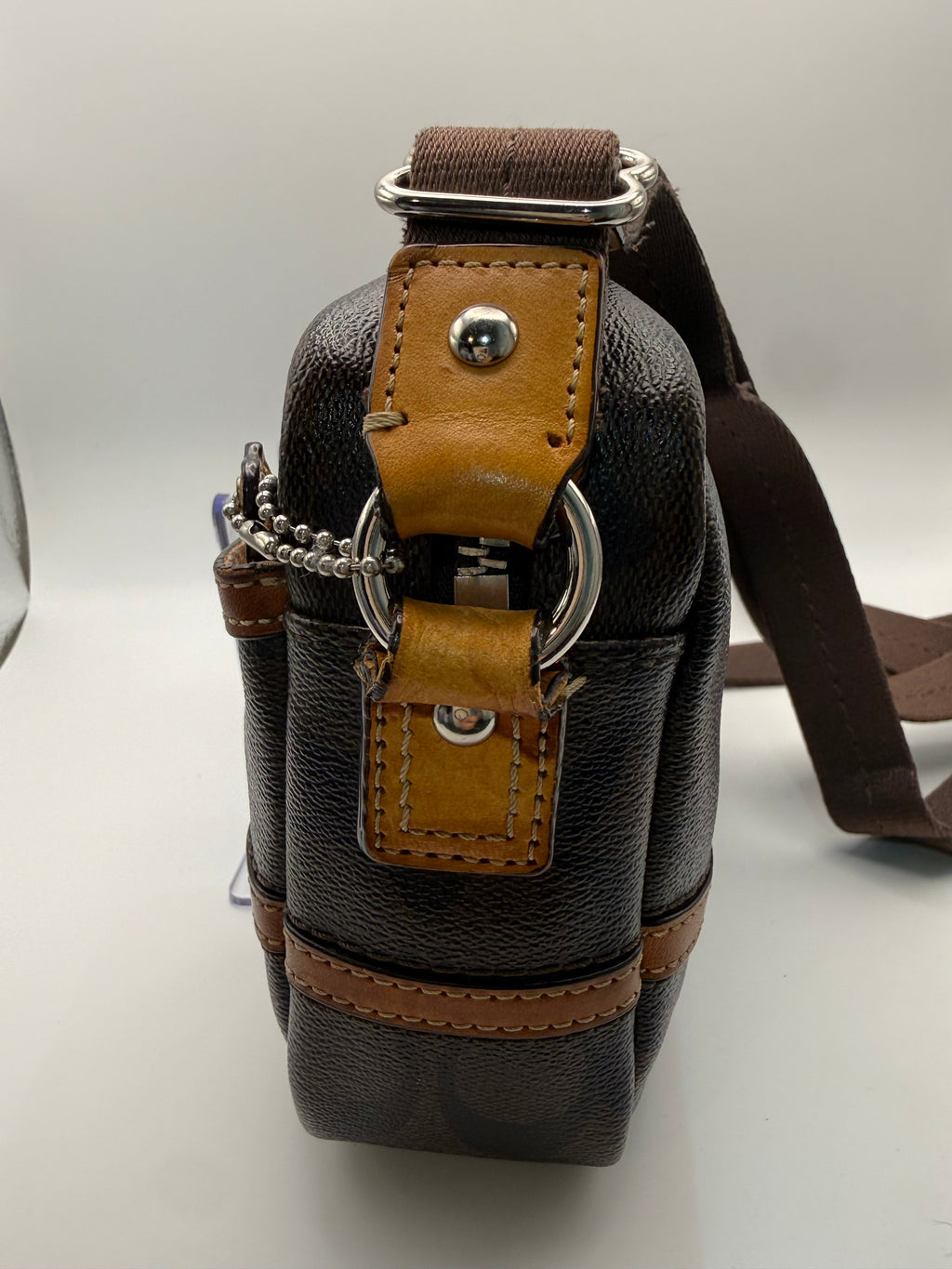Coach Crossbody Bag side hardware detail with snap closure and ring